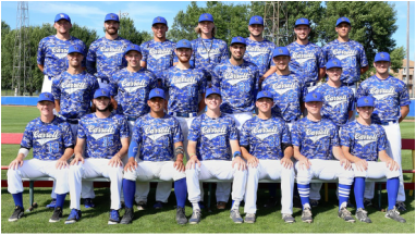 A baseball team is posing for a picture on a field.