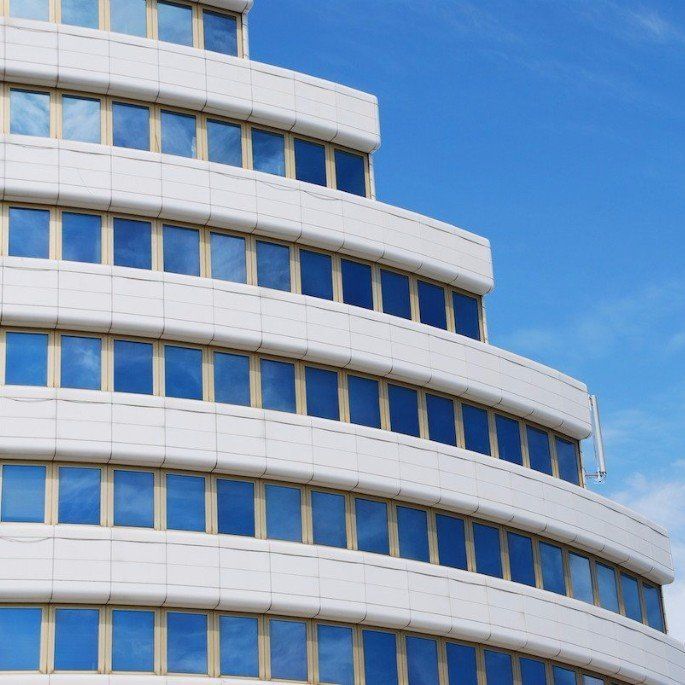 A building with a lot of windows and a blue sky in the background