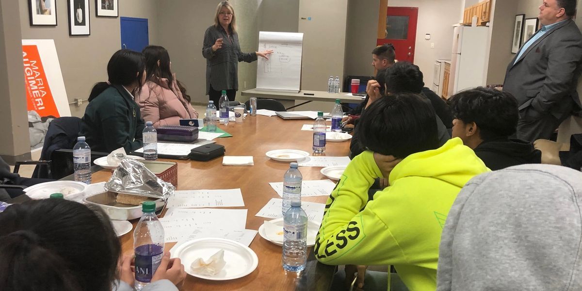 Youth meeting around a table and developing a product