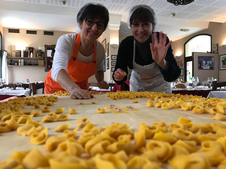people waving while cooking