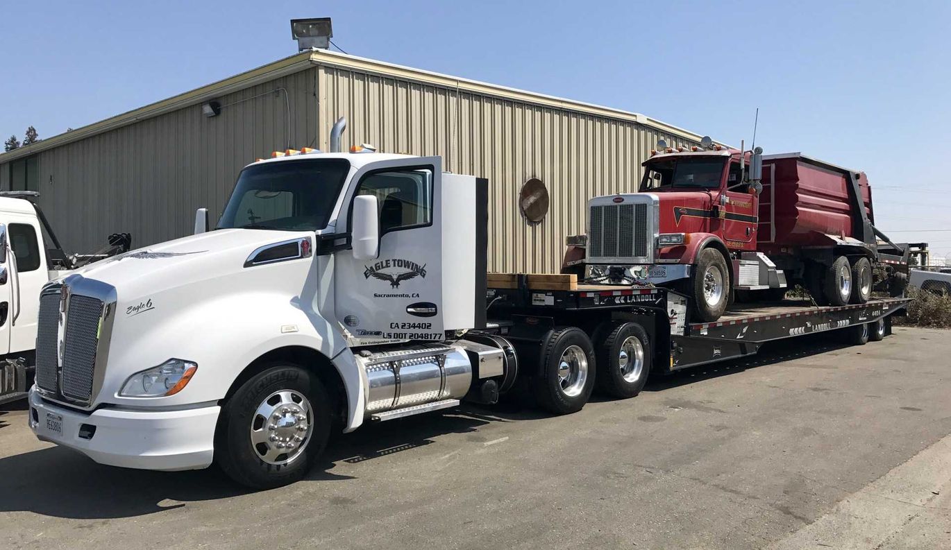 Truck Carrying Red Truck — Lockouts in Sacramento, CA
