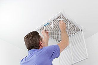 Man fixing air conditionet - HVAC Services in Kernersville, NC