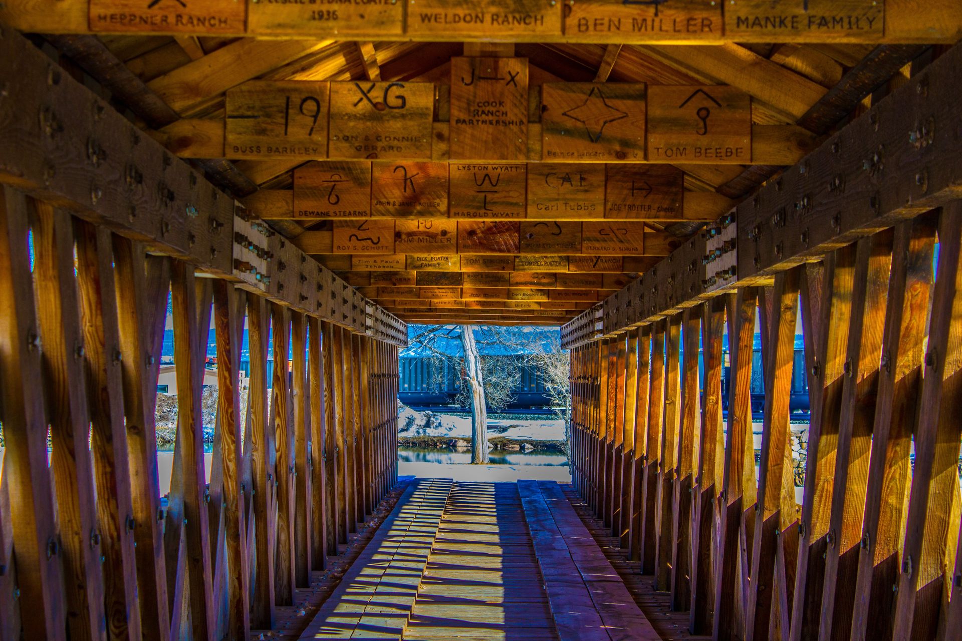 The inside of a wooden bridge with a stained glass window.
