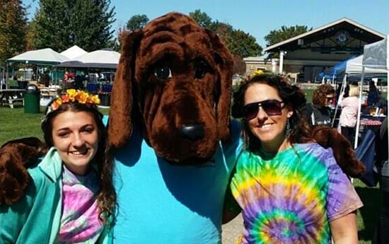 Women beside dog mascot - Dog daycare in Fishers, IN
