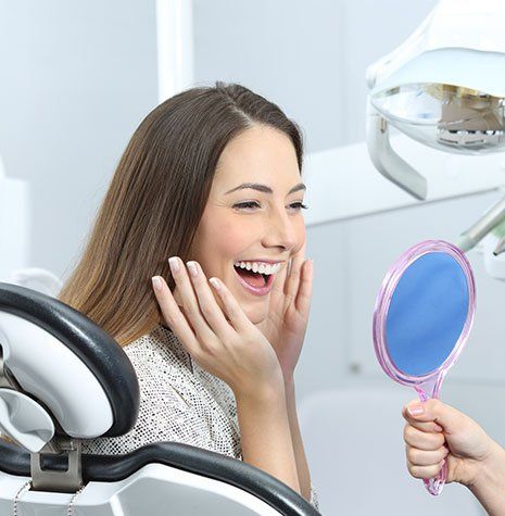 Dentist Office — Woman Checking Her Teeth in Brownsburg, IN Dentist Office — Woman Checking Her Teeth in Brownsburg, IN
