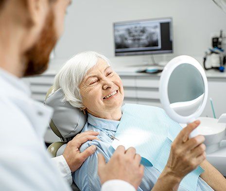Full Dentures — Senior Woman Checking the Dentures in Brownsburg, IN Full Dentures — Senior Woman Checking the Dentures in Brownsburg, IN