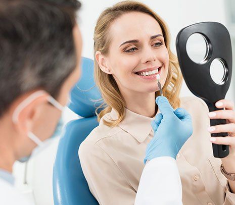 Dental Implants — Patient Checking Tooth Implant in Brownsburg, IN Dental Implants — Patient Checking Tooth Implant in Brownsburg, IN