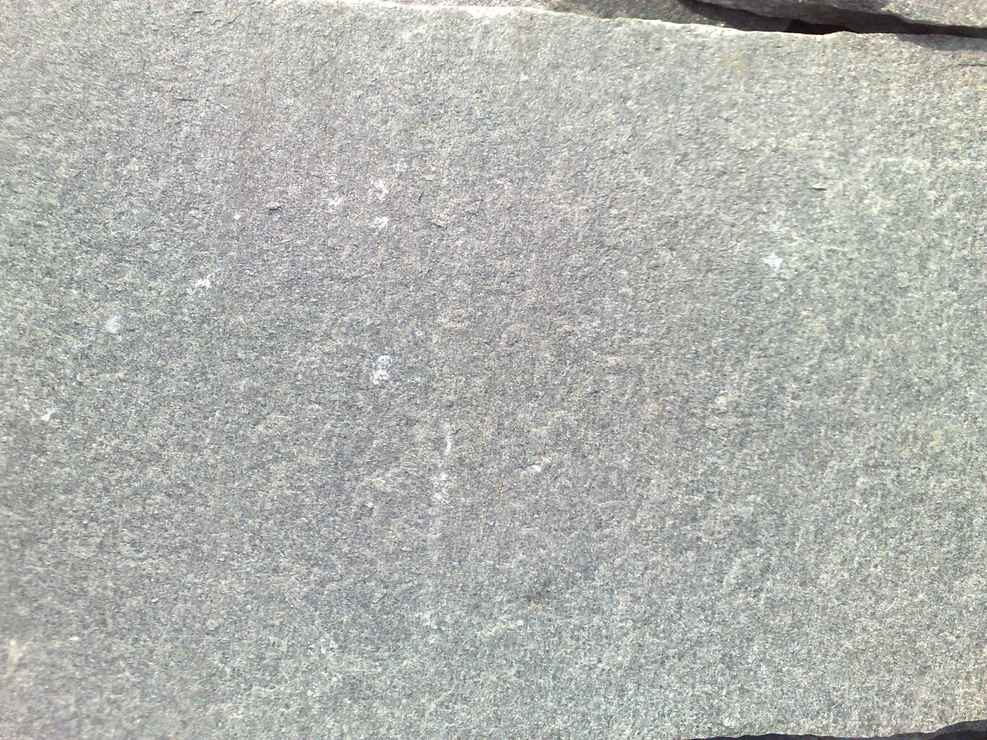 Close-up of gray stone tiles with a textured, slightly rough surface.
