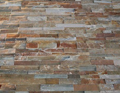 Stone wall with rectangular, multi-colored tiles.