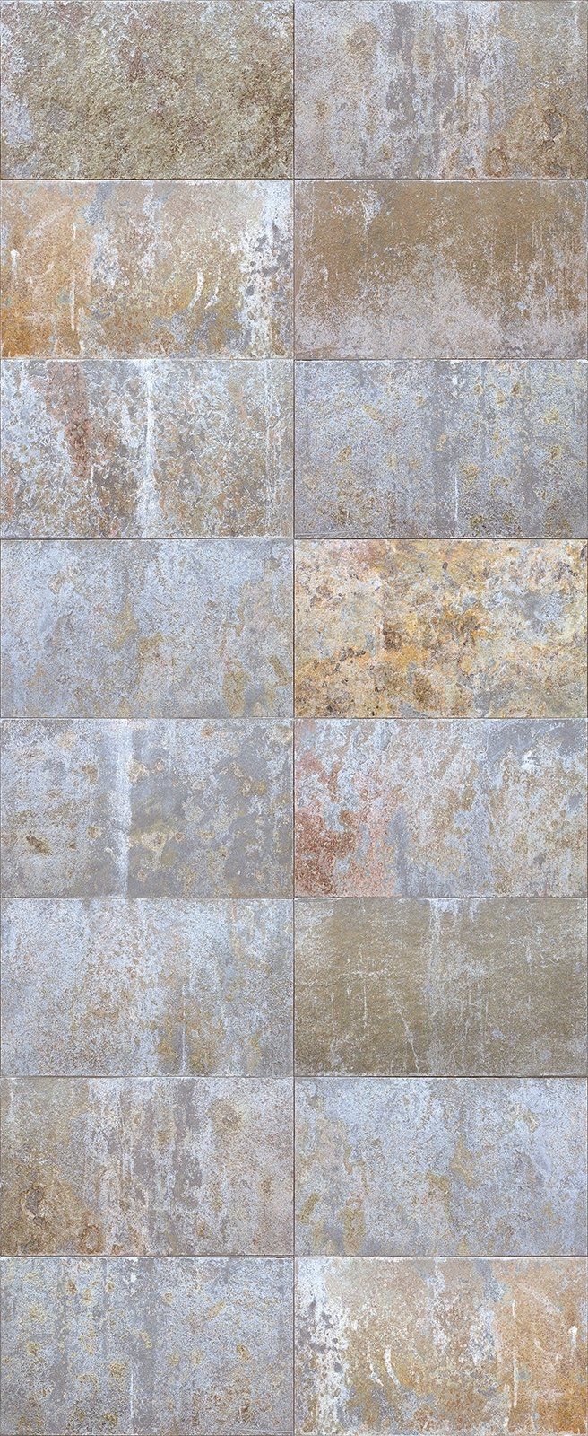 Close-up of a wall made of rectangular, textured stone tiles in shades of tan, gray, and yellow.