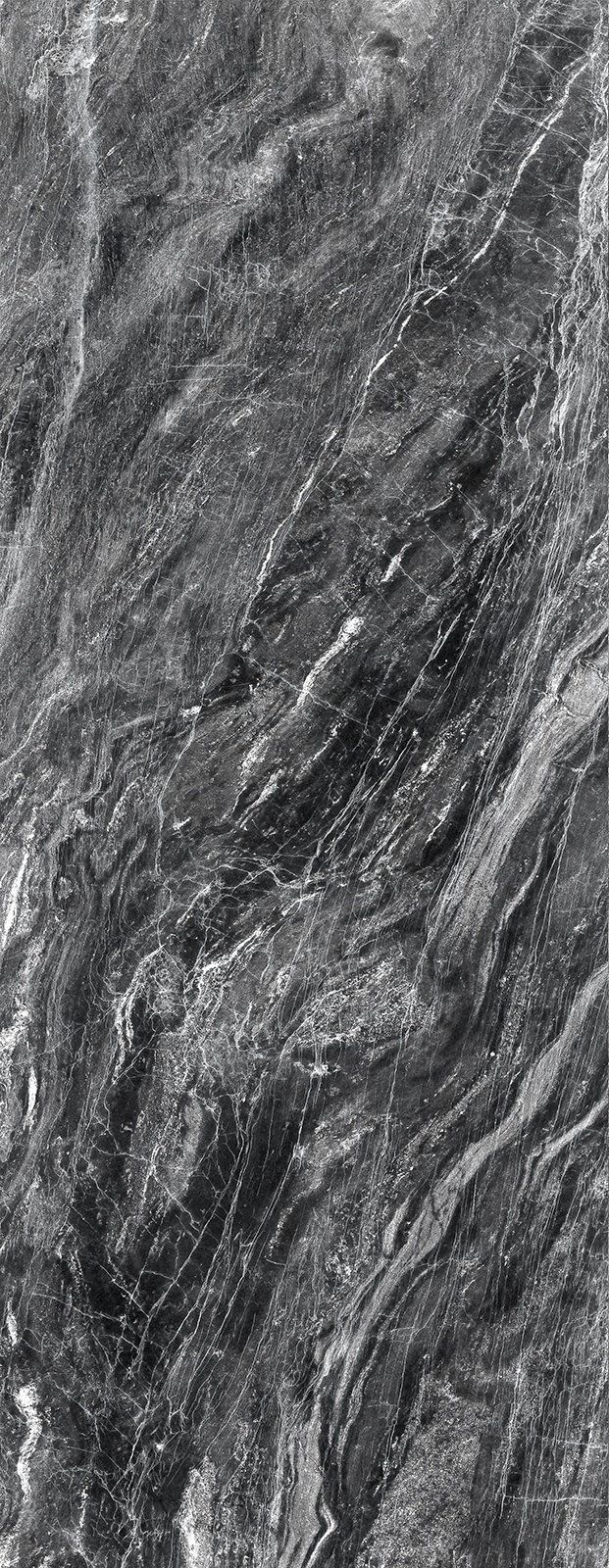 Close-up of a textured dark gray surface, possibly stone or rock, with swirling patterns.