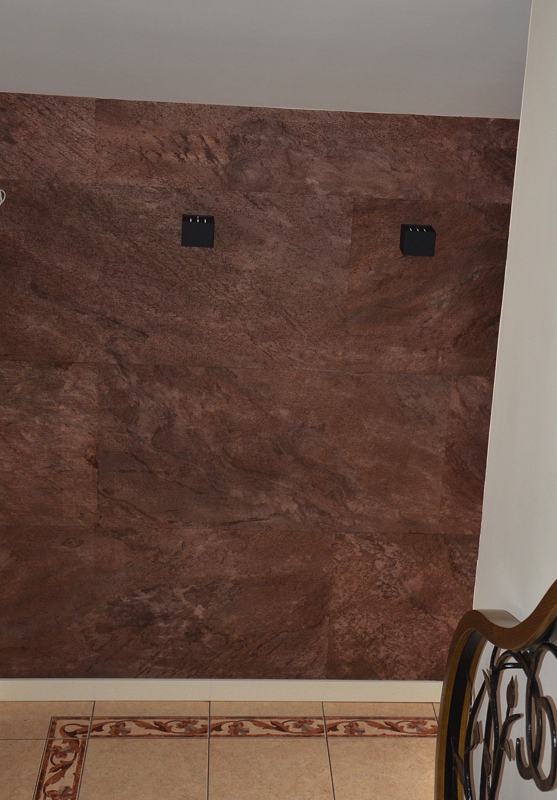 Brown textured wall with two black squares.