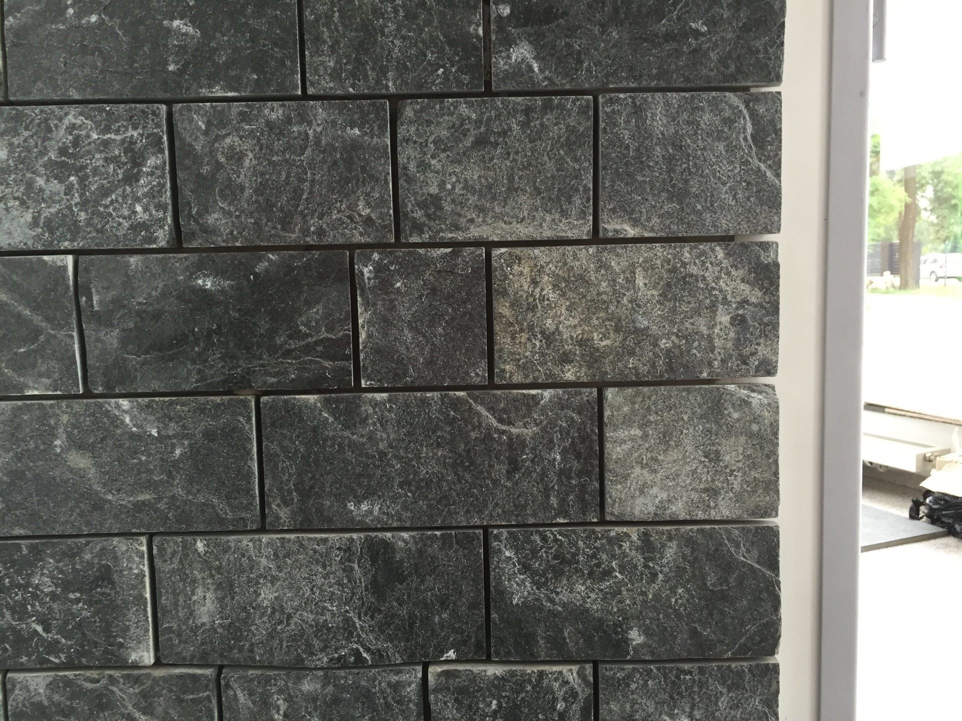 Dark gray stone brick wall.