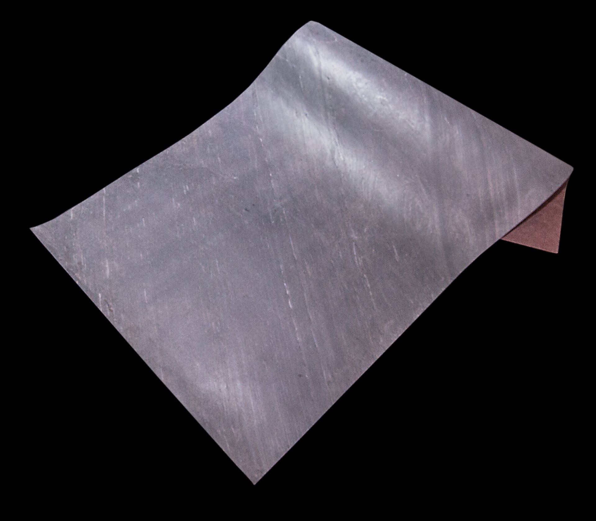 Gray sheet of paper, slightly curled at the corner, against a black background.