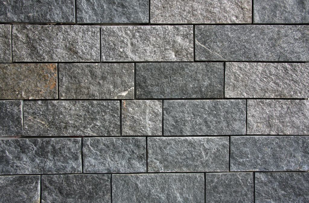 Gray and black rectangular stone brick wall.