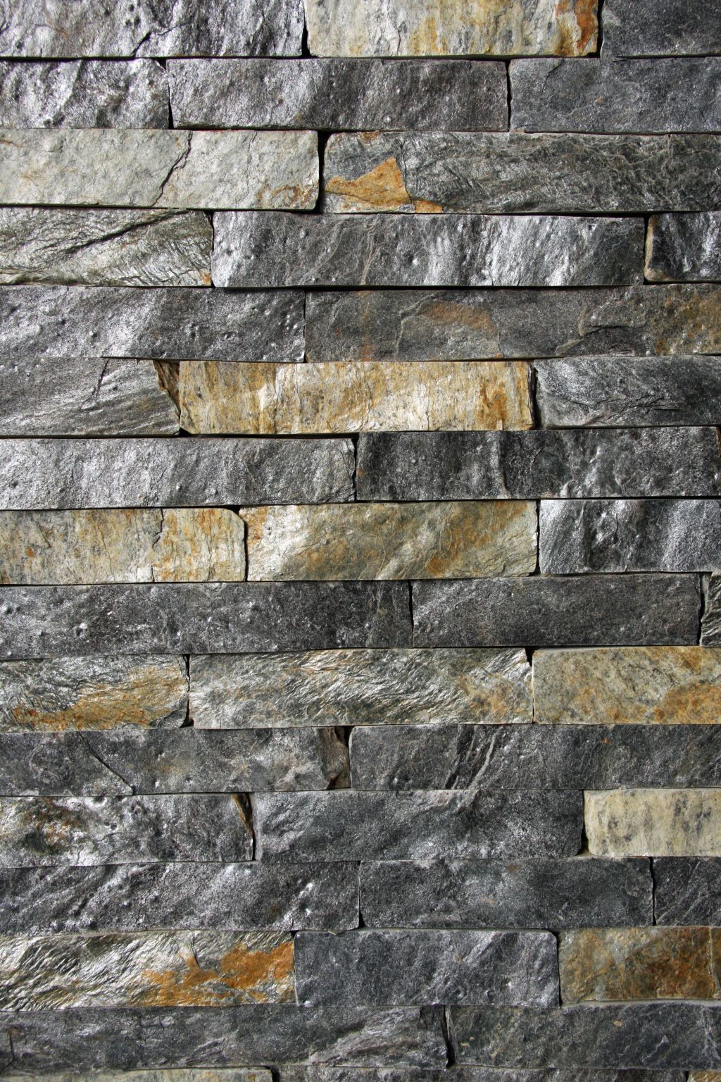 Stone wall cladding with gray, gold, and tan rectangular pieces.