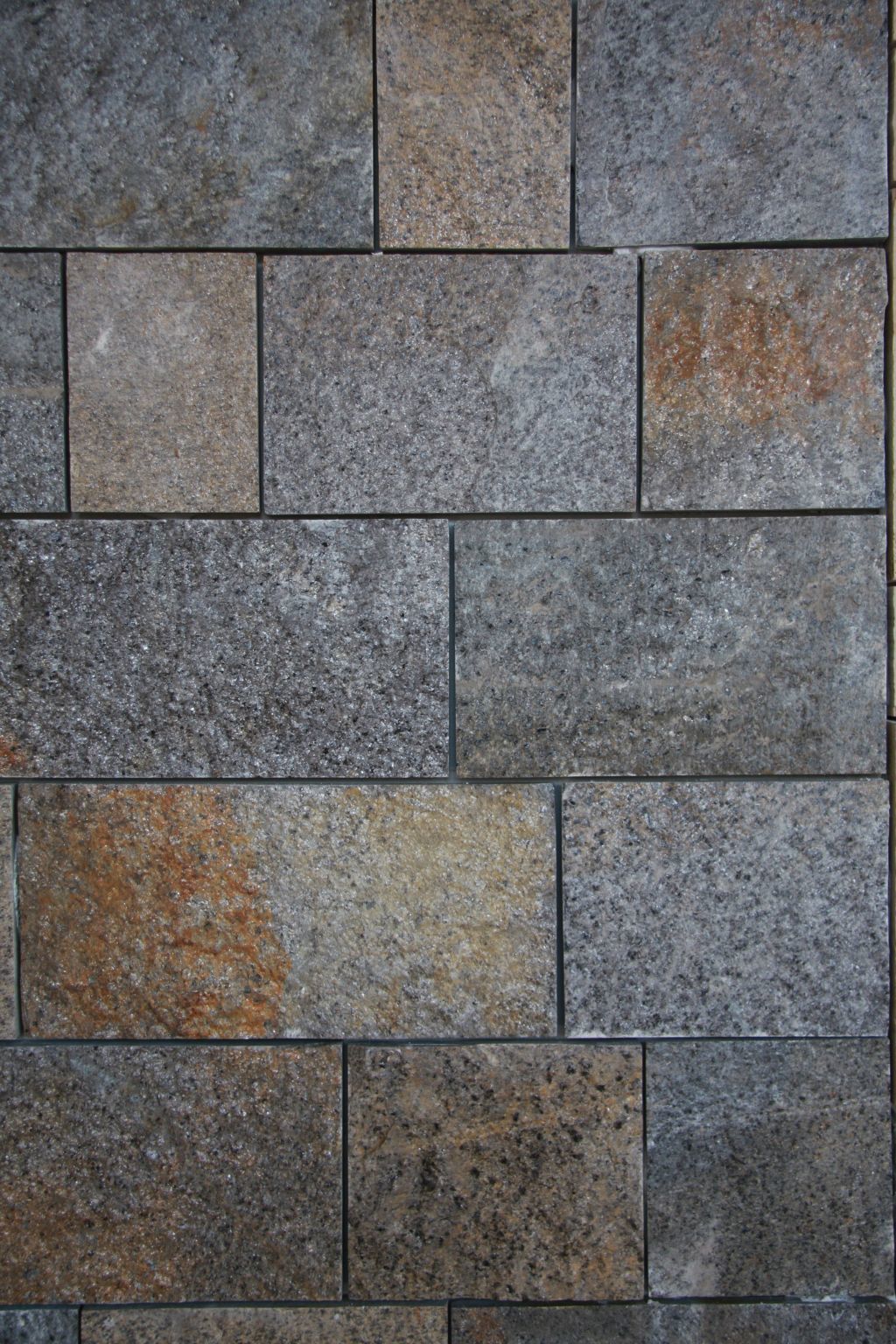 Gray and brown rectangular stone wall texture.