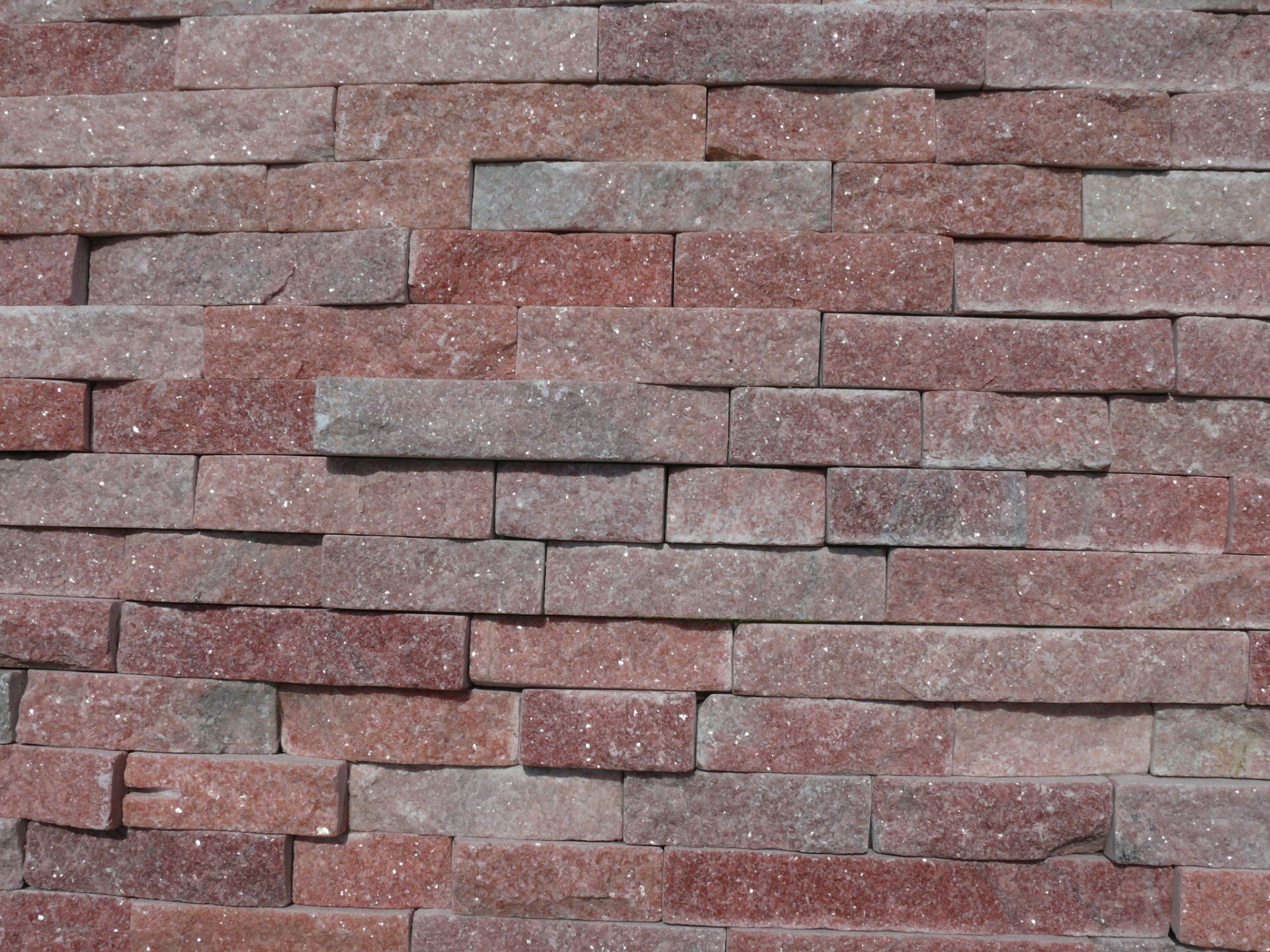 Red and gray rectangular stone brick wall.
