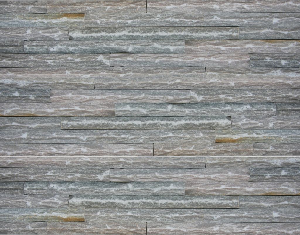 Gray and tan stone wall with horizontal, rectangular blocks.