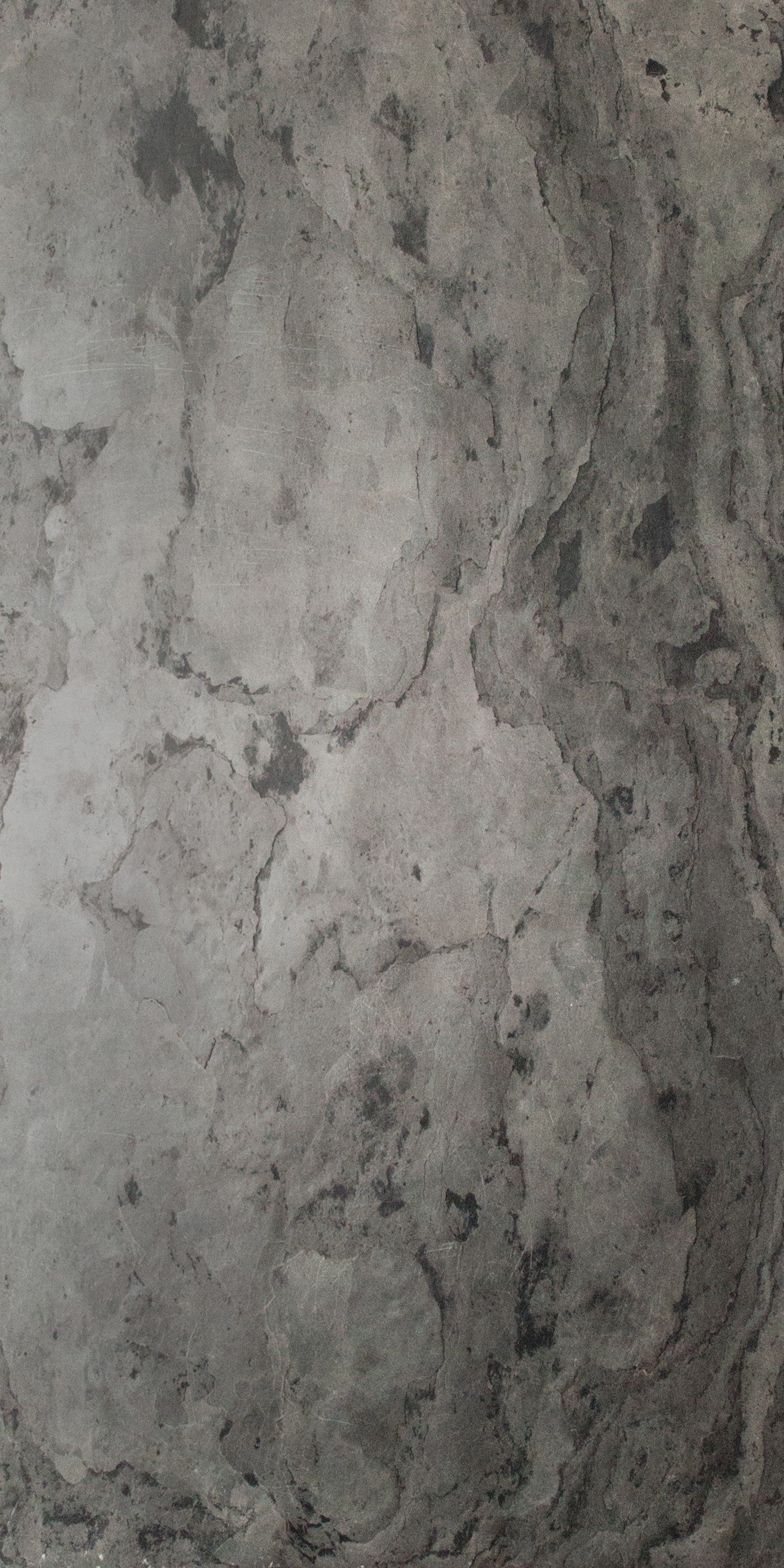 Gray concrete texture with dark patches and cracks.