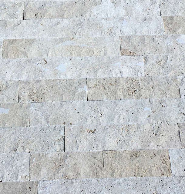 Light beige stone tile wall.