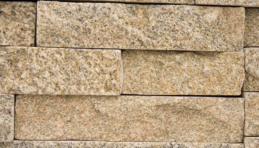 Tan and gray rectangular stone brick wall.