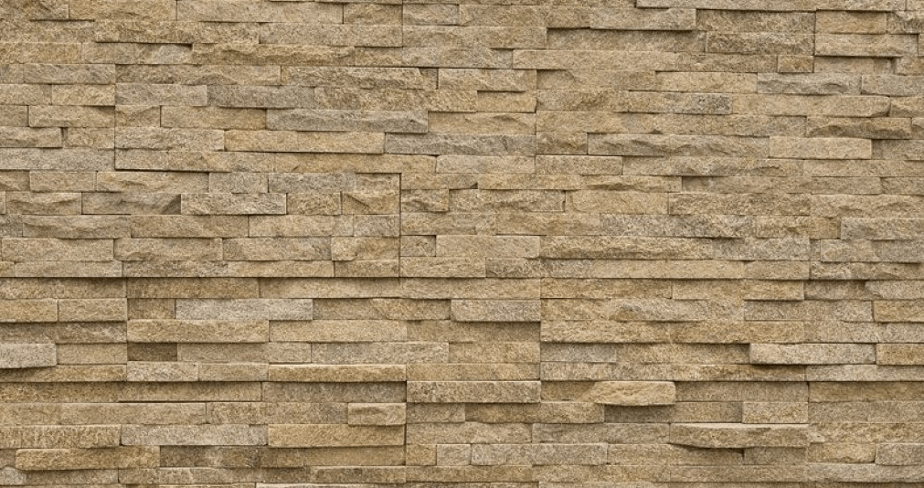 Tan-colored stone wall with horizontal rectangular bricks of varying lengths and slight texture variation.