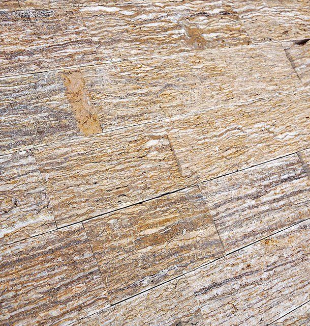 Brown and tan stone tile flooring with layered horizontal texture.