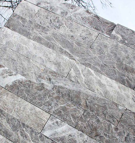 Gray marble brick wall, diagonally arranged, with white veining.