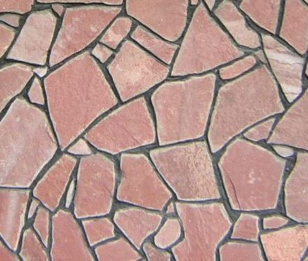 Pink flagstone patio with dark grout lines.