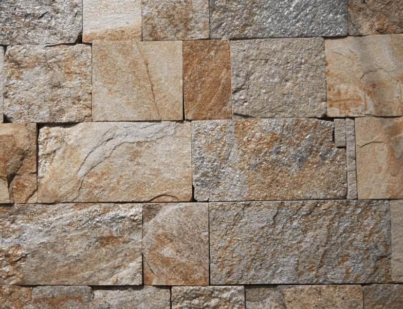 Close-up of a stone brick wall with varying shades of brown, beige, and gray.