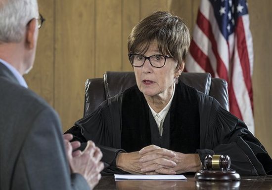 Female judge with male attorney in courtroom discussing bail in Waterbury Female judge with male attorney in courtroom discussing bail in Waterbury