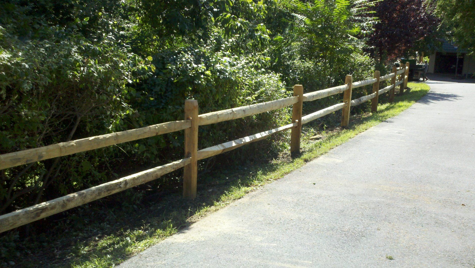 A wooden fence along the side of a road