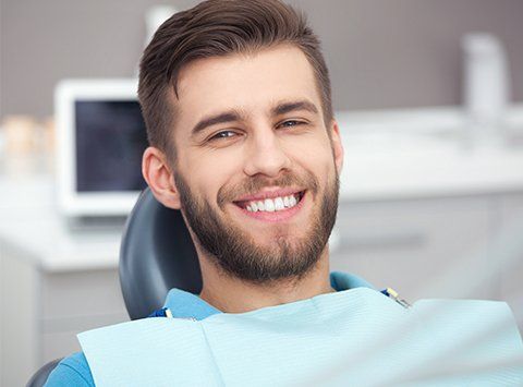 Periodontics Dentists — Happy Patient on Dental Chair in Birmingham, AL Periodontics Dentists — Happy Patient on Dental Chair in Birmingham, AL