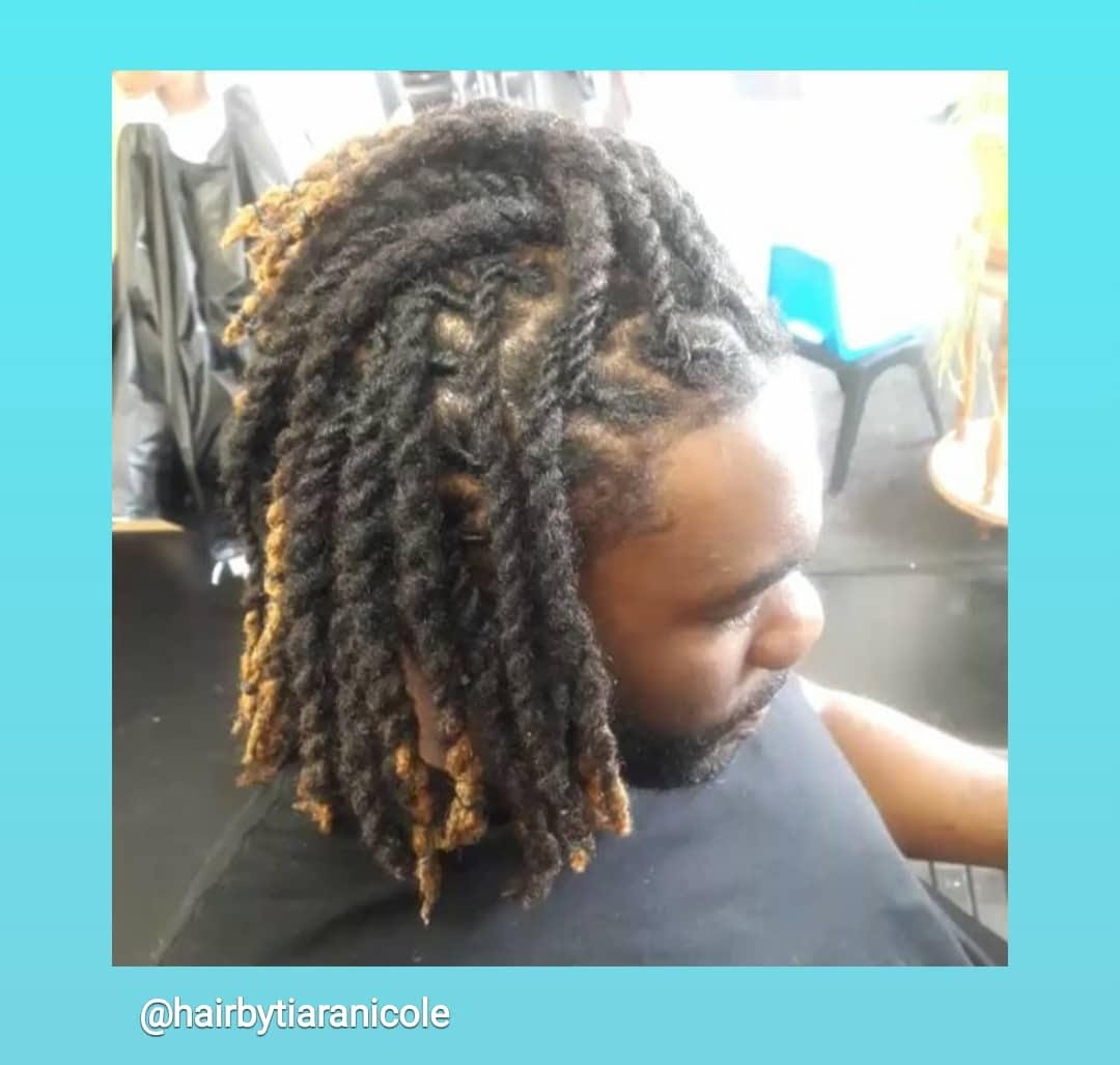 Side view of medium-length twisted locs in a salon chair, with blond-highlighted ends.