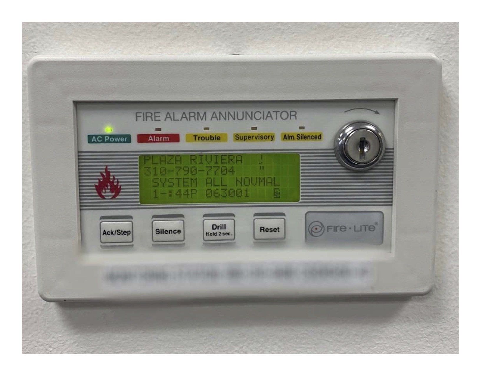 a fire alarm annunciator with a key on it