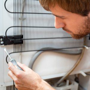 Man during fridge repair - Barbecue Care in South Jersey, NJ