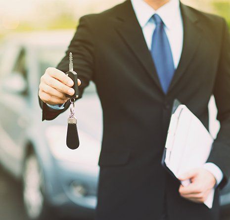Specialist offering the car keys