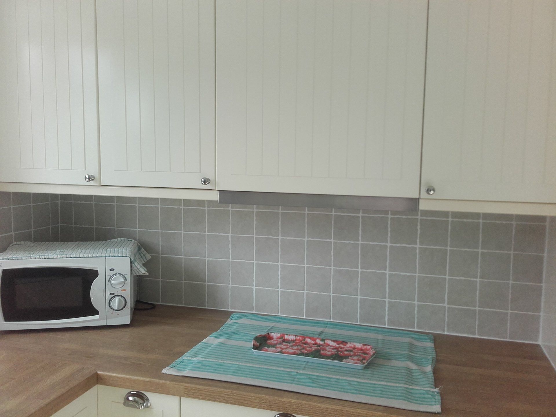 white kitchen cabinets fitted about worktop