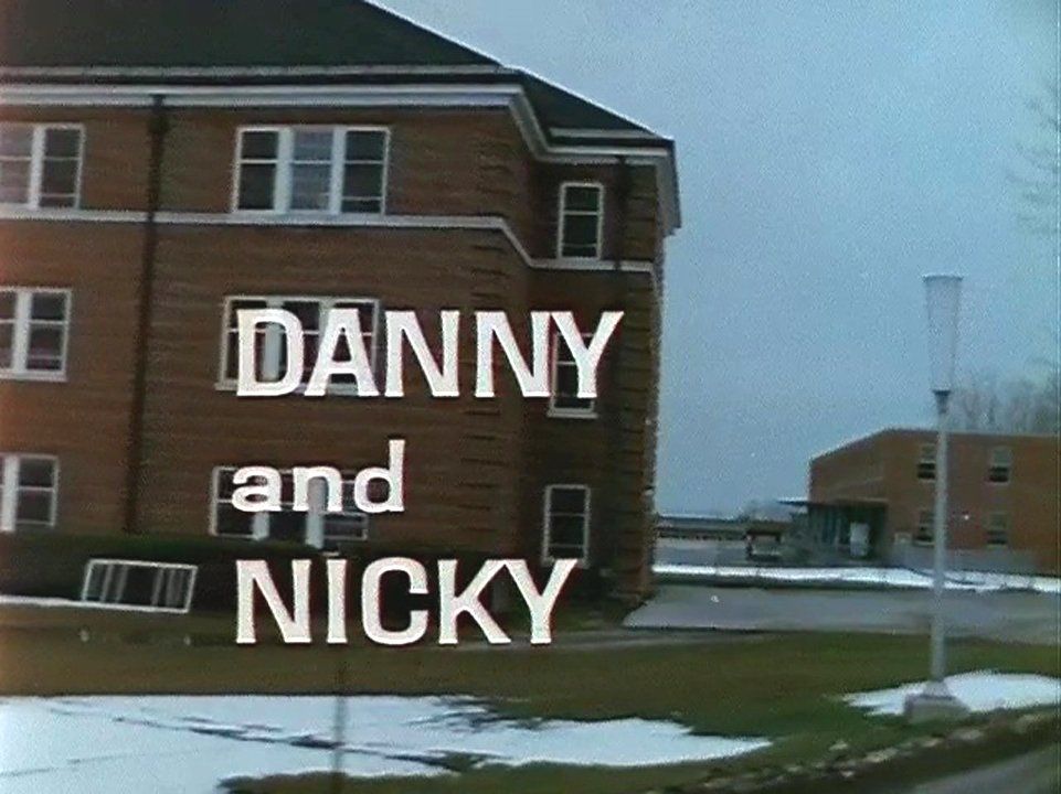 The title screen from the documentary Danny and Nicky, showing the film’s title superimposed over Cottage O on an overcast winter day. Image from the National Film Board of Canada documentary Danny and Nicky. The title screen from the documentary Danny and Nicky, showing the film’s title superimposed over Cottage O on an overcast winter day. Image from the National Film Board of Canada documentary Danny and Nicky.