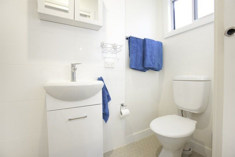 white bathroom with blue towels