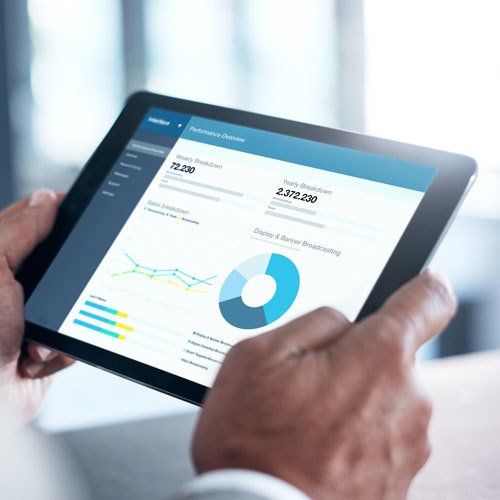 Cropped shot of a businessman using a digital tablet with graphs on the screen