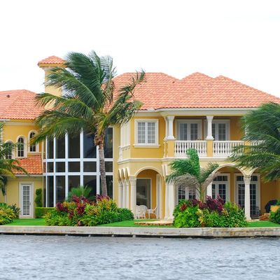 estate agent giving house keys to woman and sign agreement in office