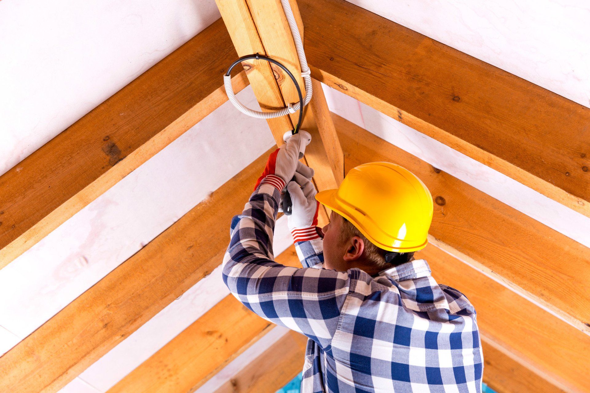 Flooring — Electrician Working with wires at Attic in Gray, GA