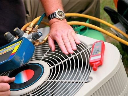 A Man Checking the Condition of Air Conditioner — Belle Haven, VA — Thornton Services Inc.