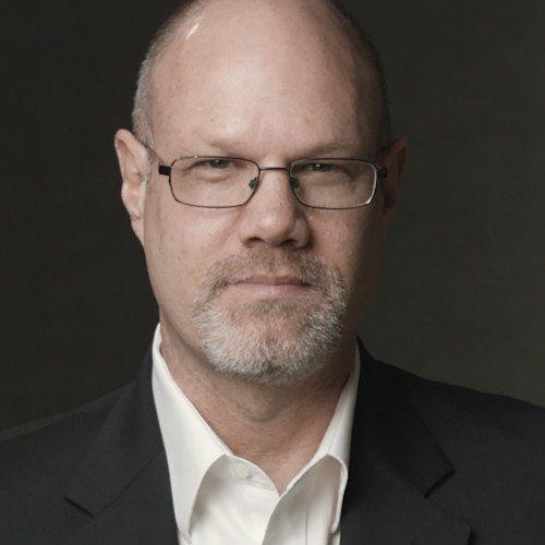 thomas hill, third generation leader, kimray inc, oklahoma, white collar shirt, dark suite, bald, metal glasses, facial hair