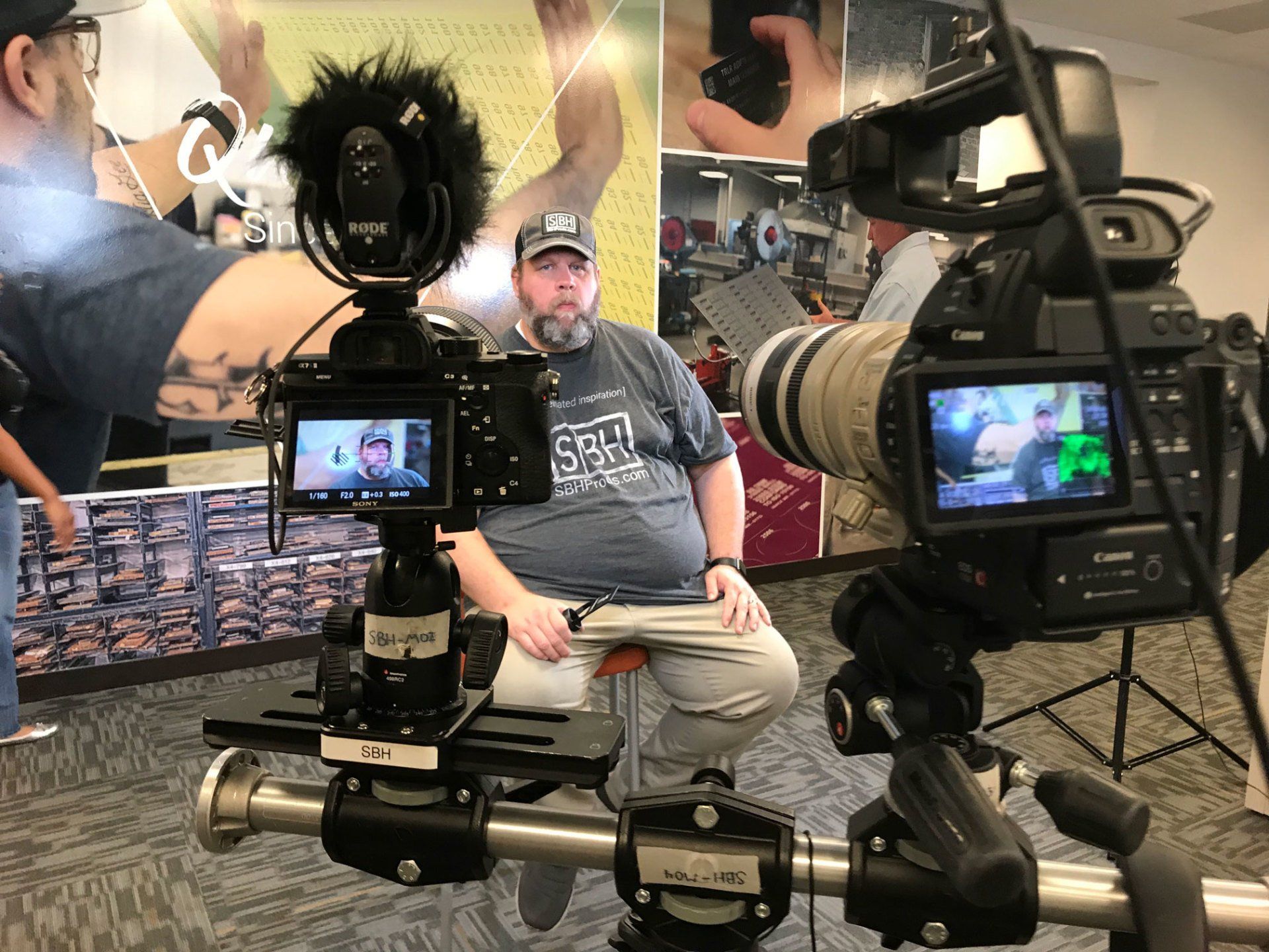 man sitting infront of two camera interview setup, behind the scenes corporate video production(justin riley)