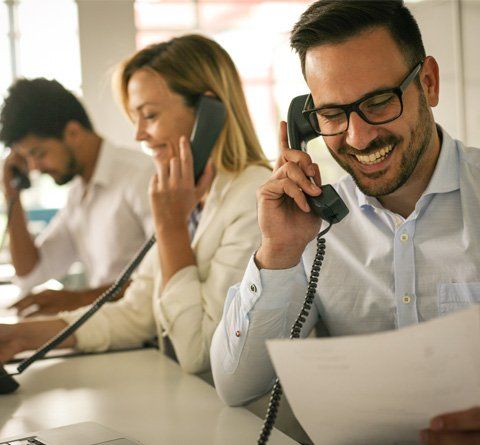 Appointment Scheduling — Man Smiling While On Call in Calabasas, CA Appointment Scheduling — Man Smiling While On Call in Calabasas, CA