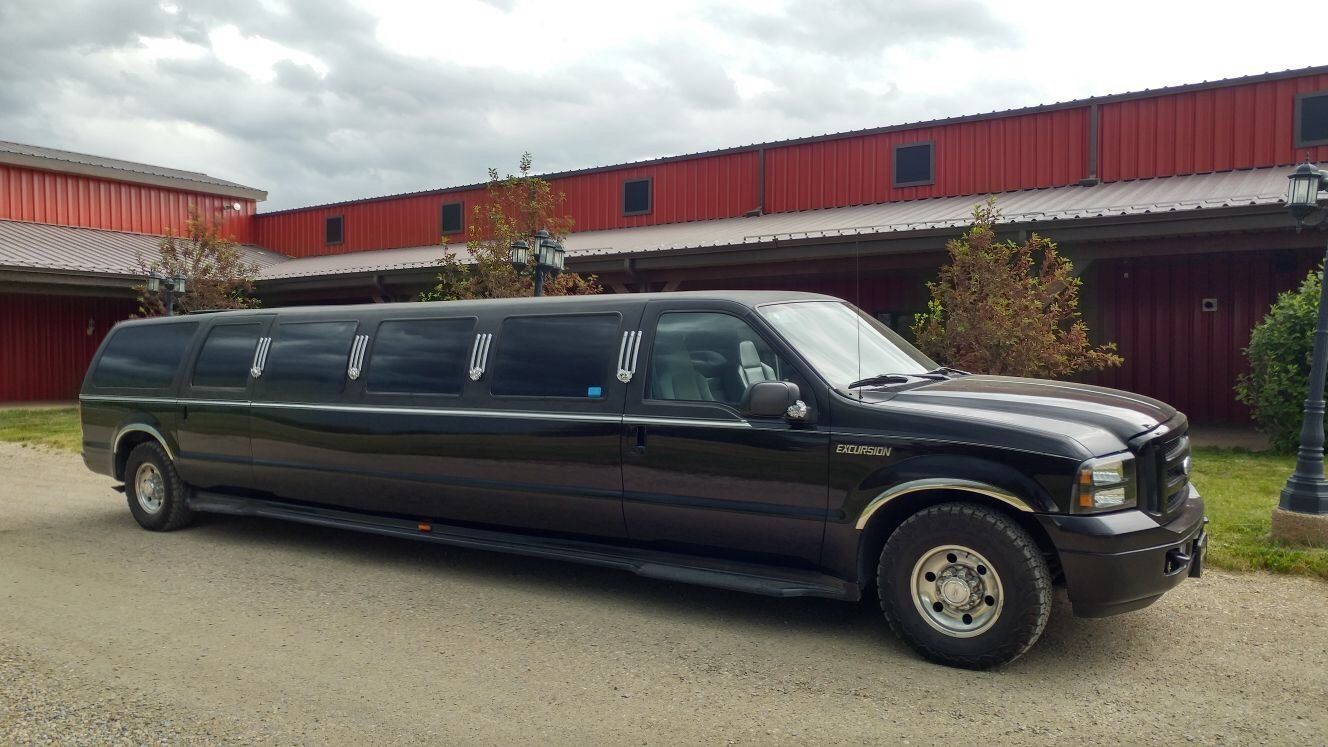 black Excursion 14 passenger stretch SUV limousine parked at wedding venue