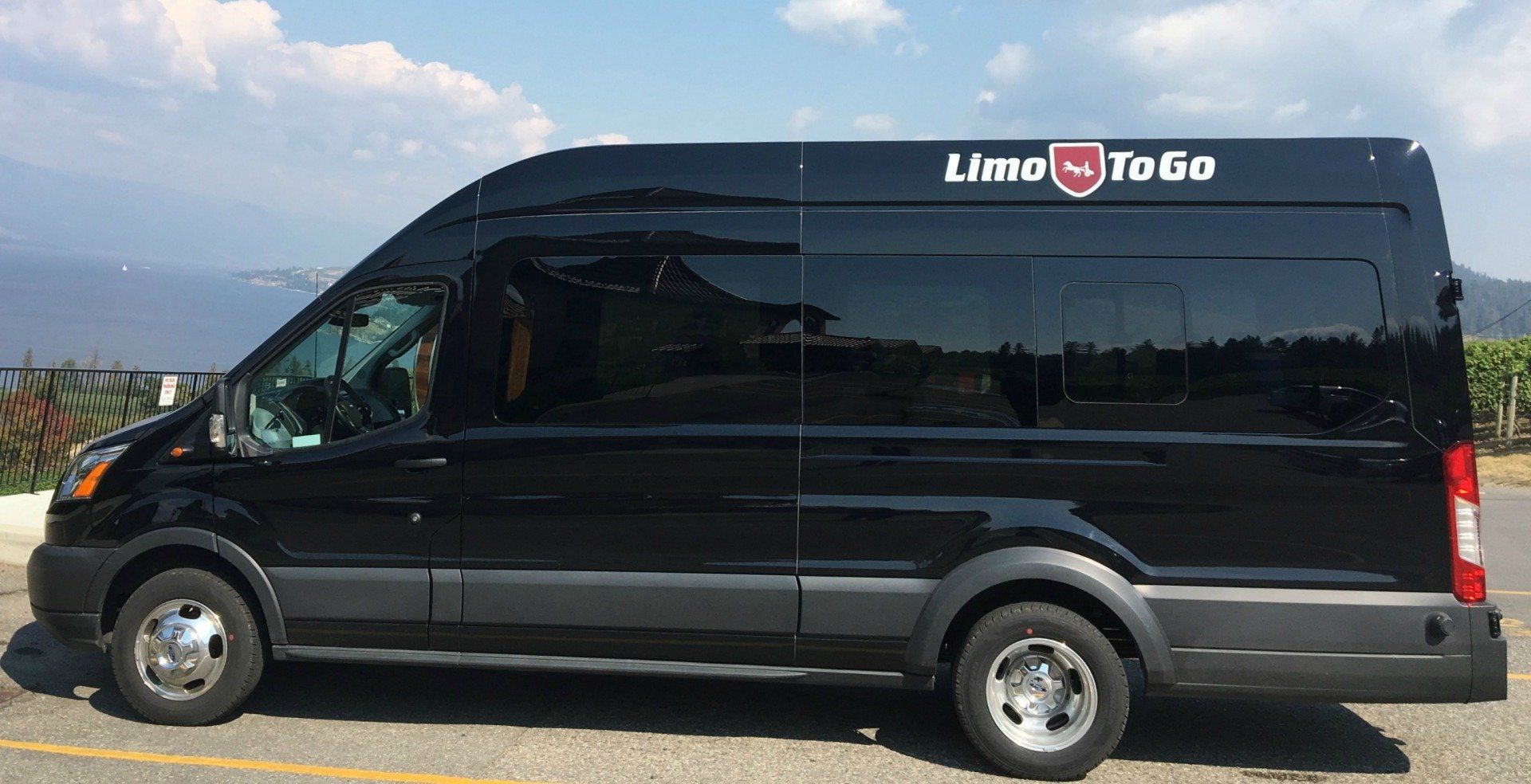 black Transit 14 passenger shuttle bus exterior